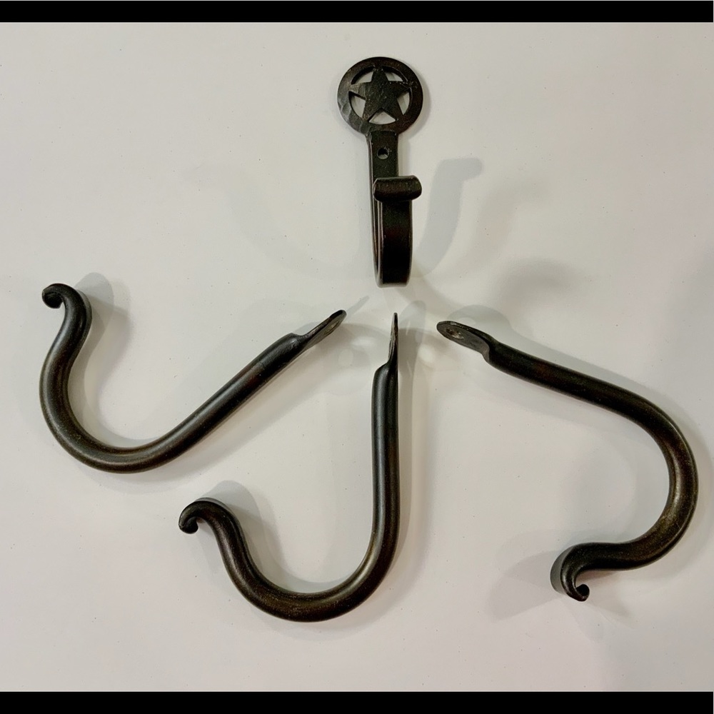 FOUR hand forged iron hooks.